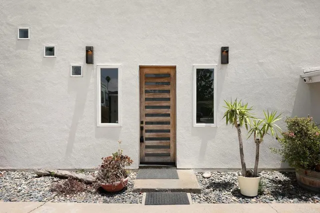 a vase with flowers on a floor