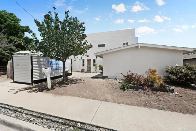a backyard of a house with plants and trees