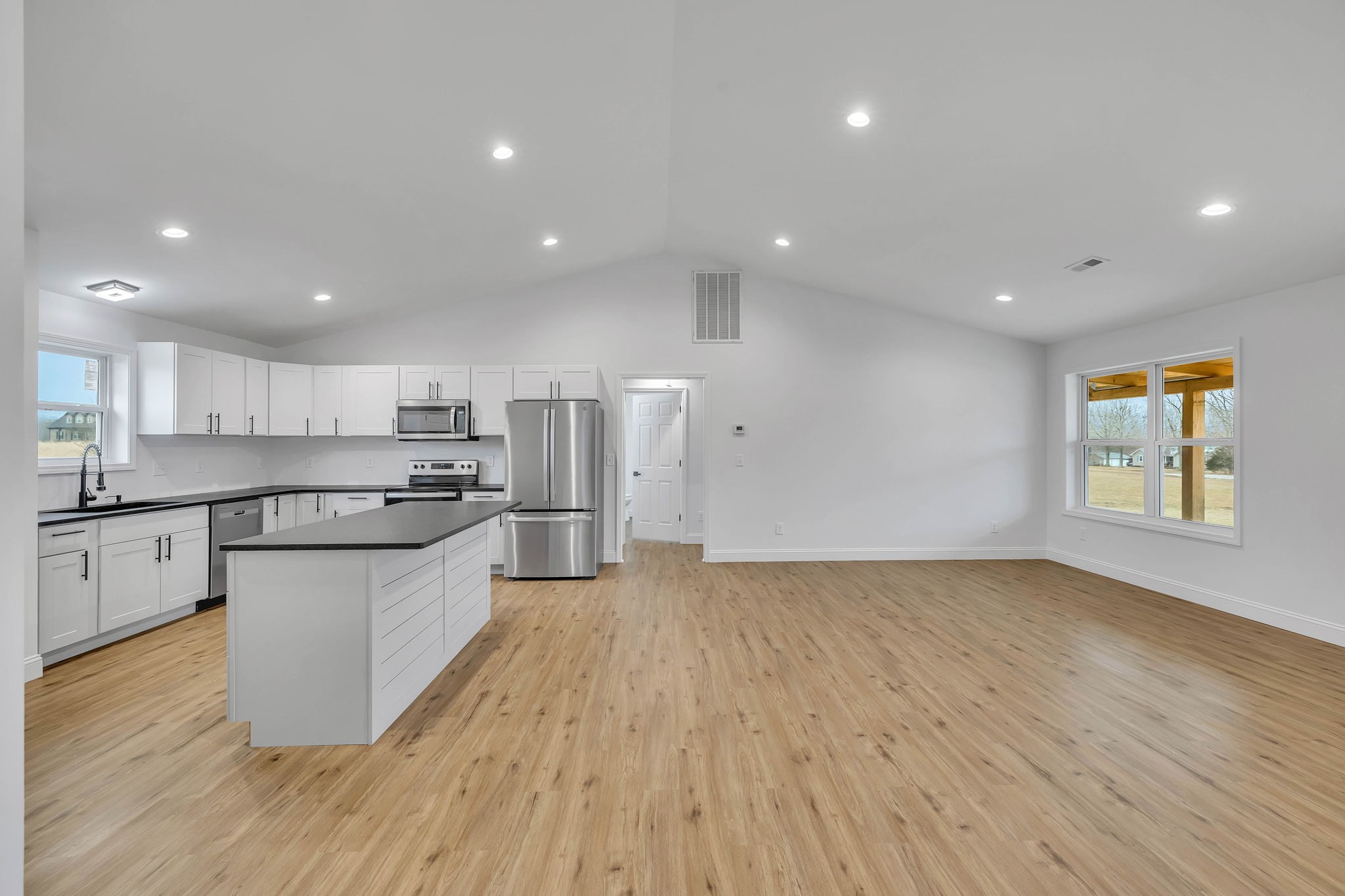 129 Colonial Road Hohenwald, TN 38462 - Photo 13 of 33 a large kitchen with stainless steel appliances granite countertop a large counter top a sink and a stove