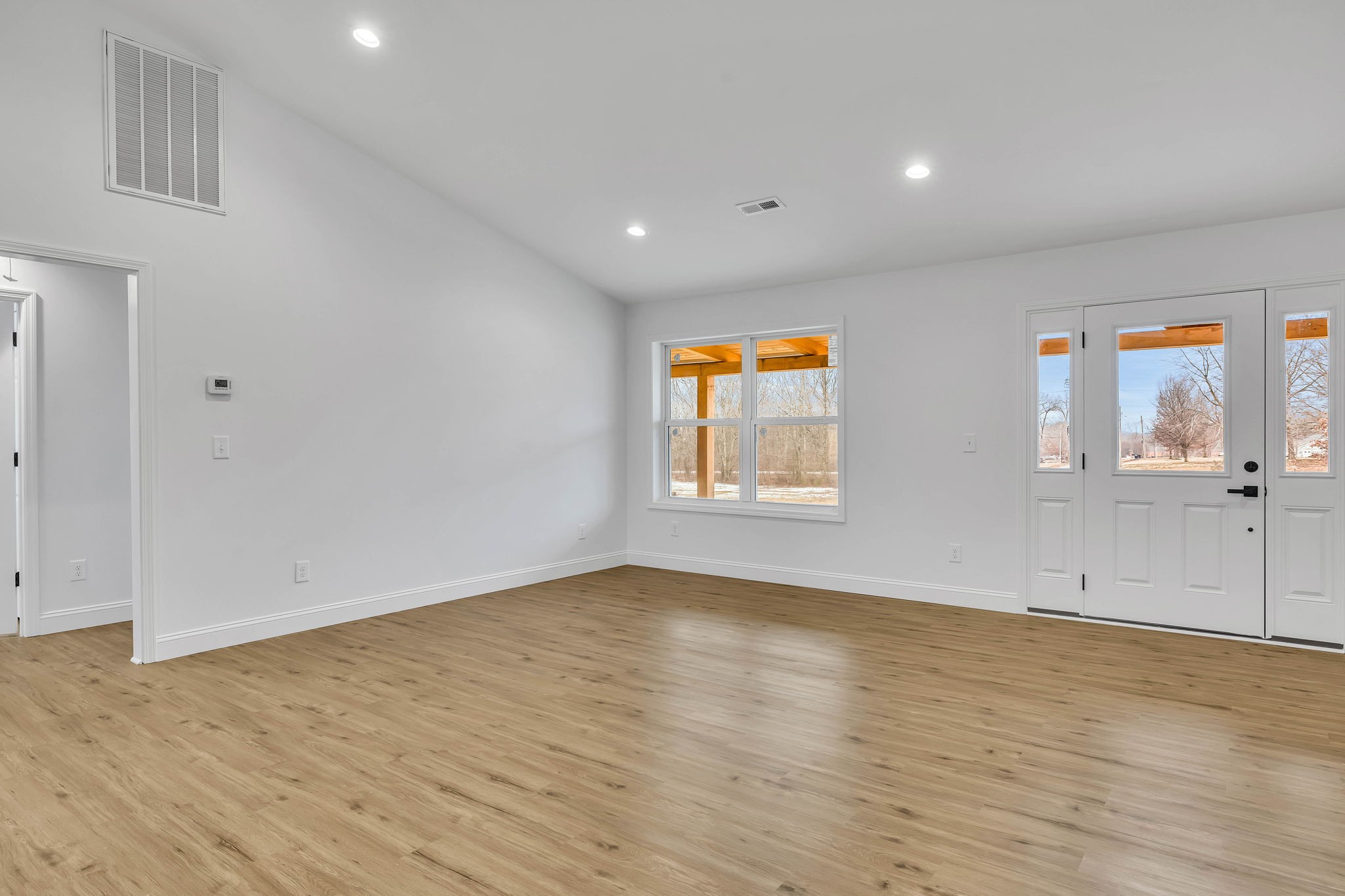 129 Colonial Road Hohenwald, TN 38462 - Photo 14 of 33 wooden floor in an empty room with a window