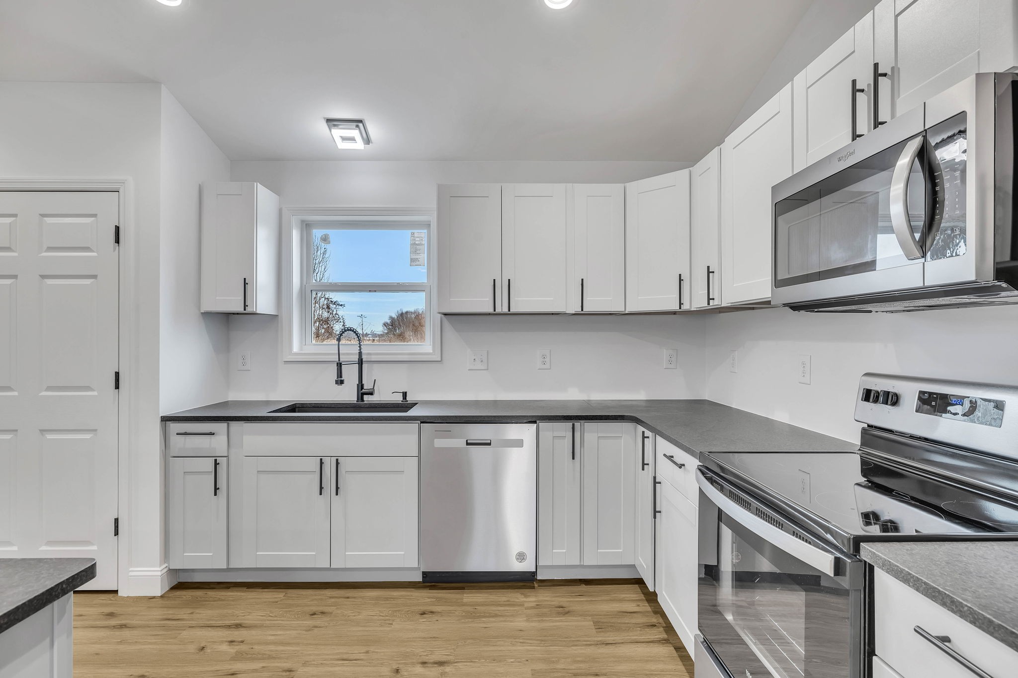 129 Colonial Road Hohenwald, TN 38462 - Photo 20 of 33 a kitchen with stainless steel appliances granite countertop a sink stove and microwave
