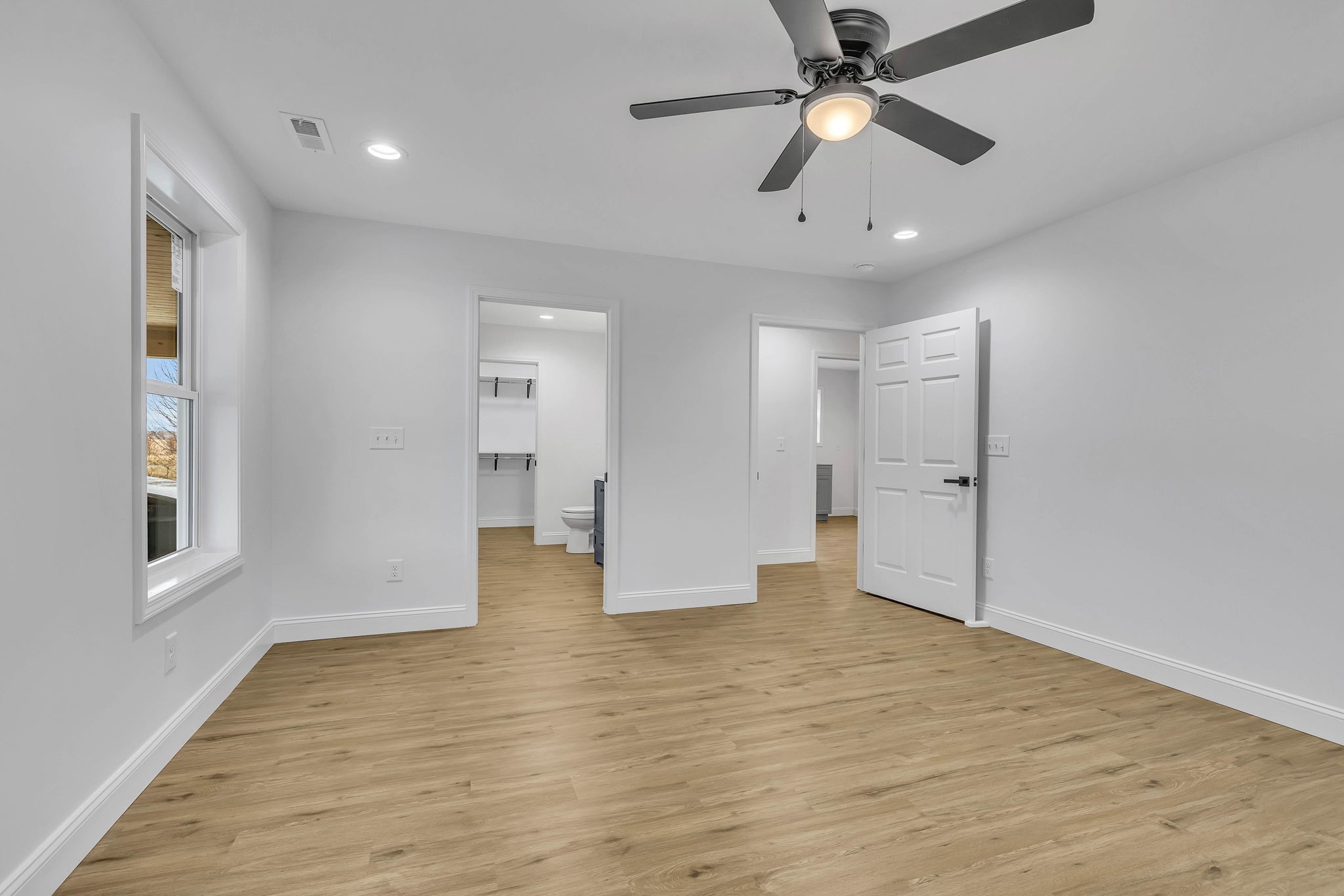 129 Colonial Road Hohenwald, TN 38462 - Photo 24 of 33 a view of an empty room with window and wooden floor