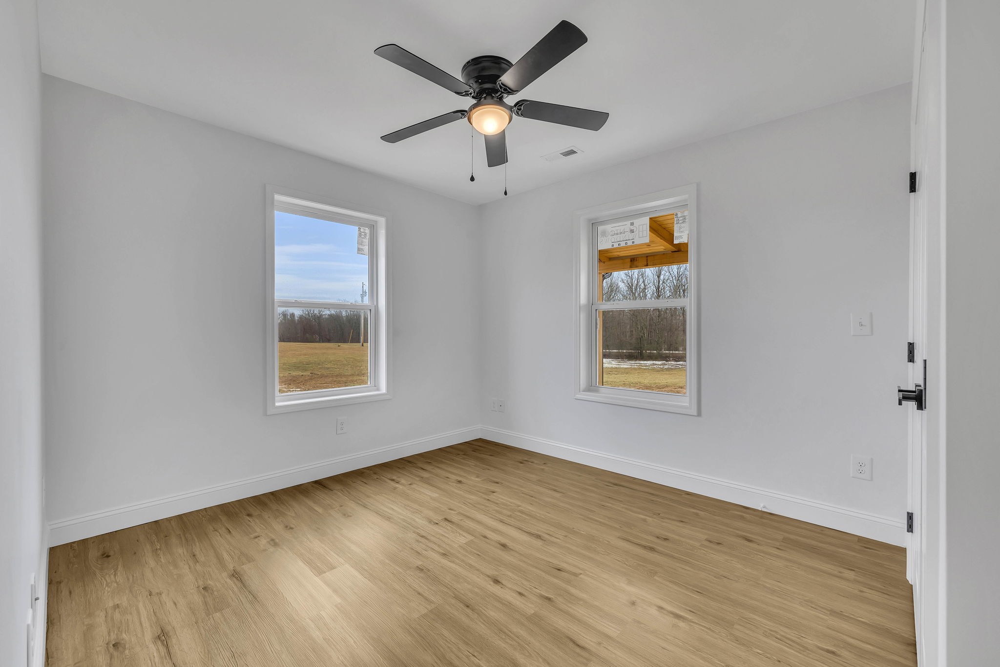 129 Colonial Road Hohenwald, TN 38462 - Photo 30 of 33 a view of an empty room with window and wooden floor