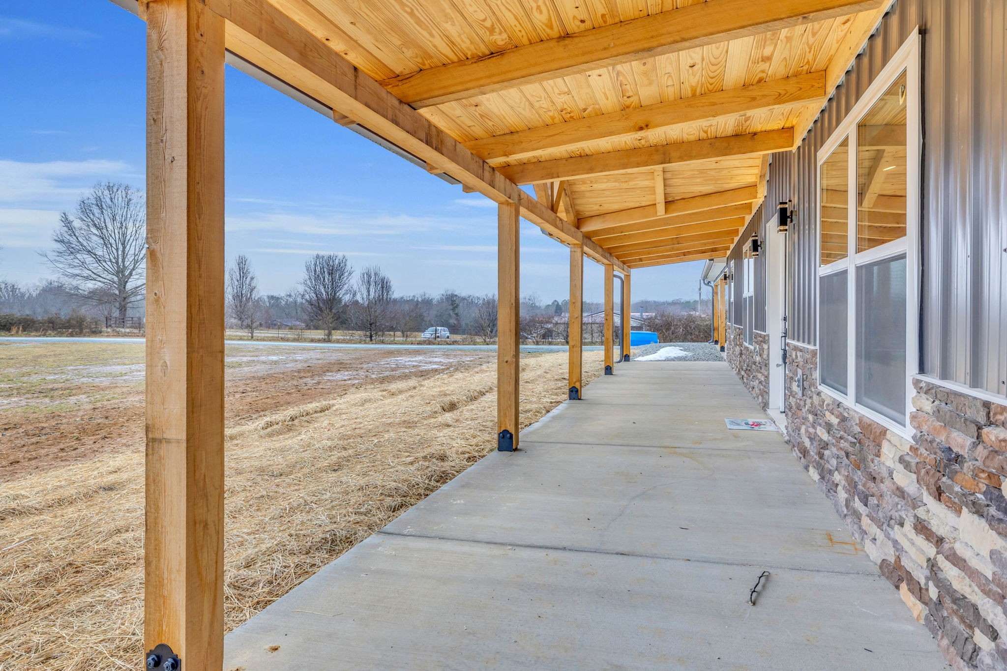 129 Colonial Road Hohenwald, TN 38462 - Photo 5 of 33 a view of a room with wooden floor and iron stairs