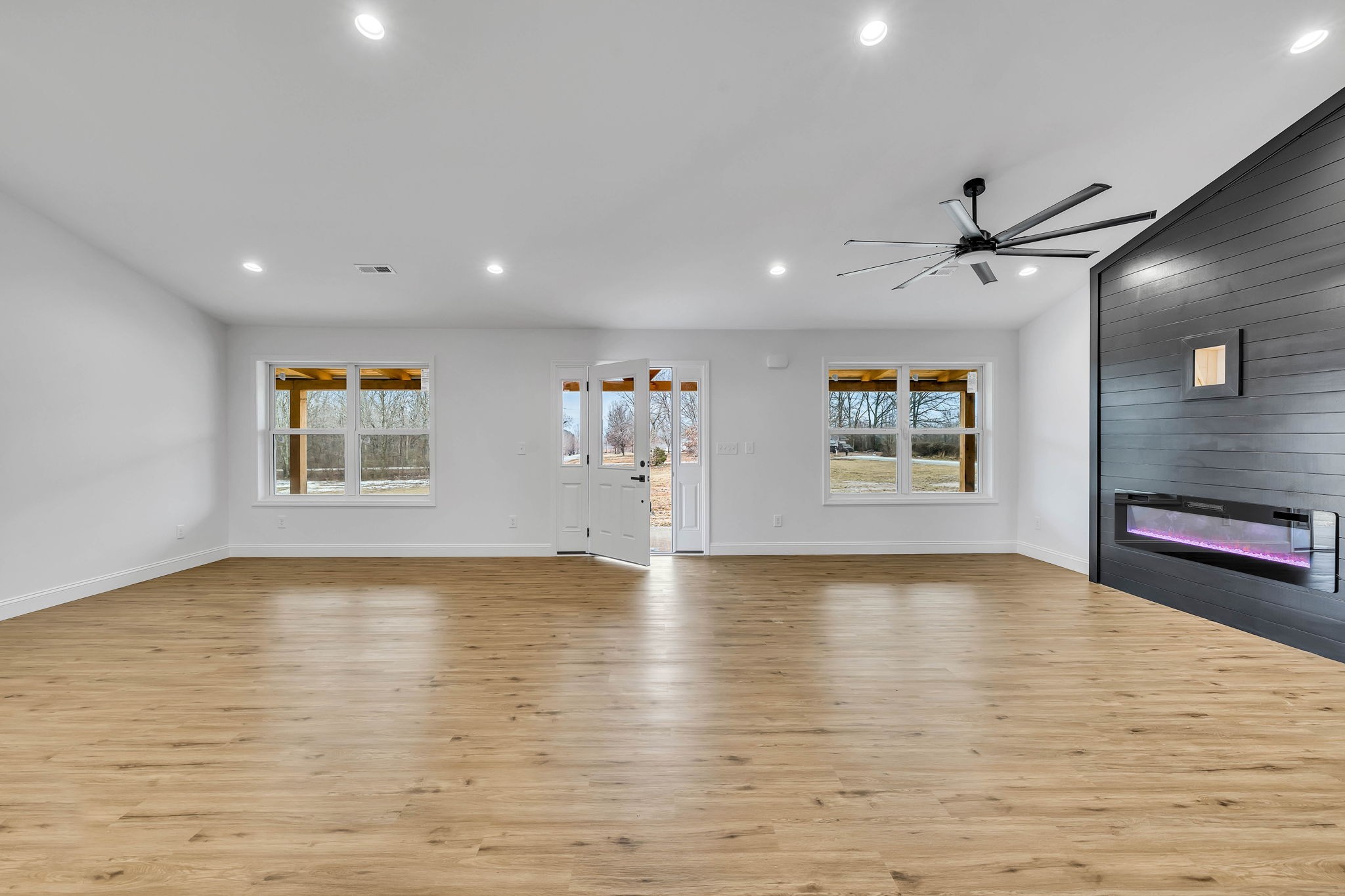 129 Colonial Road Hohenwald, TN 38462 - Photo 8 of 33 a view of an empty room with window and wooden floor
