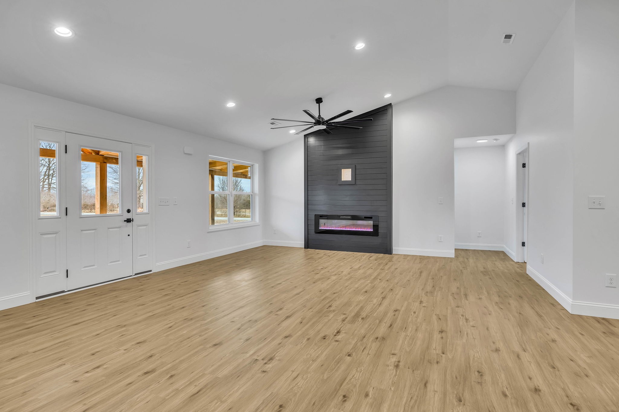 129 Colonial Road Hohenwald, TN 38462 - Photo 9 of 33 a view of empty room with wooden floor and window
