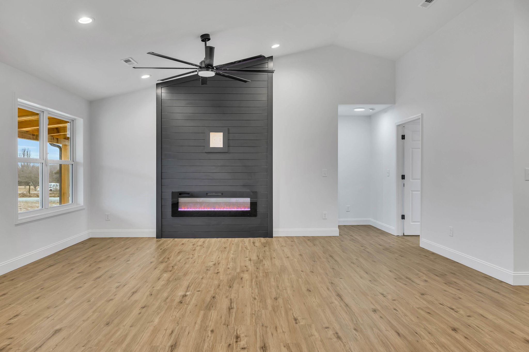 129 Colonial Road Hohenwald, TN 38462 - Photo 10 of 33 a view of an empty room with wooden floor and a window