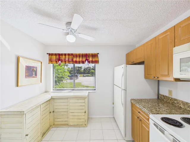 a kitchen with a stove a refrigerator and a sink