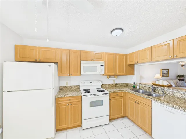 a kitchen with a white cabinets and white appliances