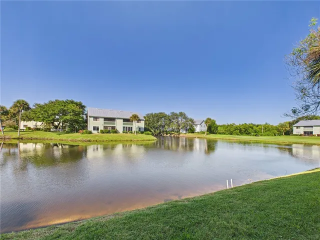 a view of a lake with houses in the back