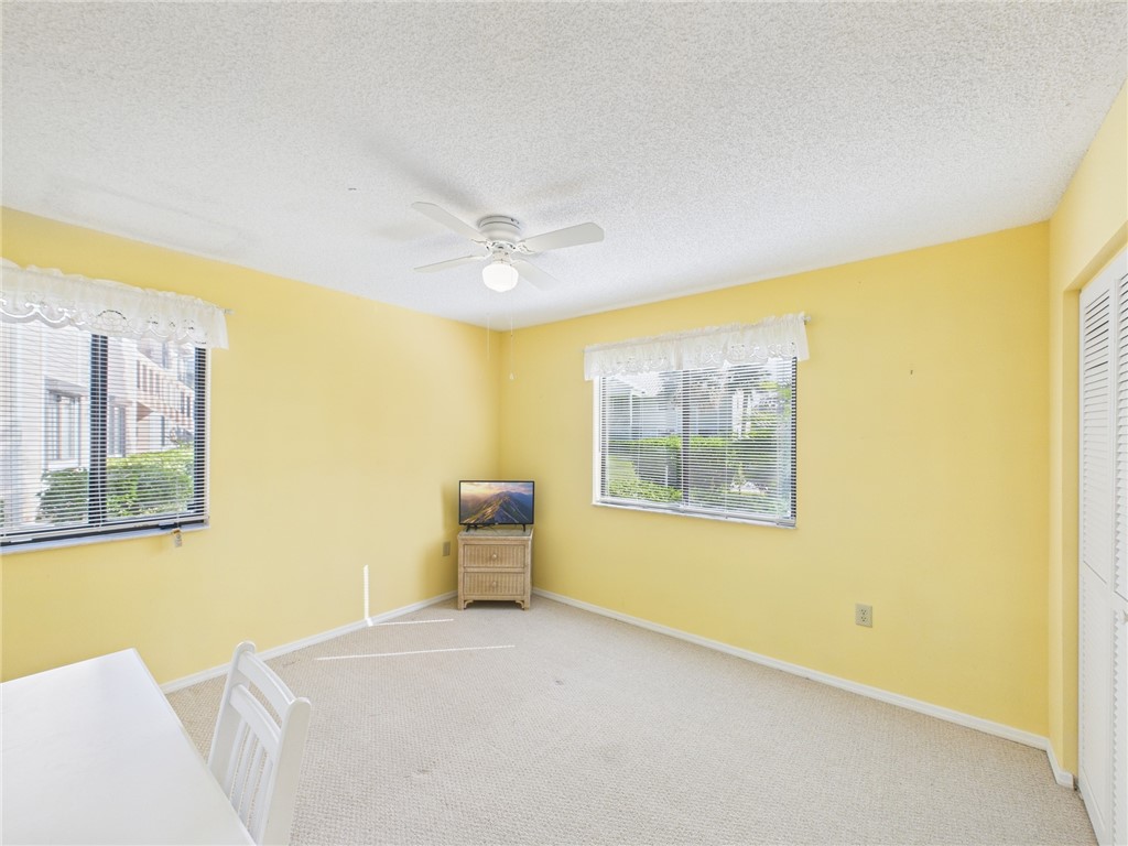 5730 Pelican Pointe Drive, Unit 2 Sebastian, FL 32958 - Photo 7 of 19 a bedroom with a bed and wooden floor