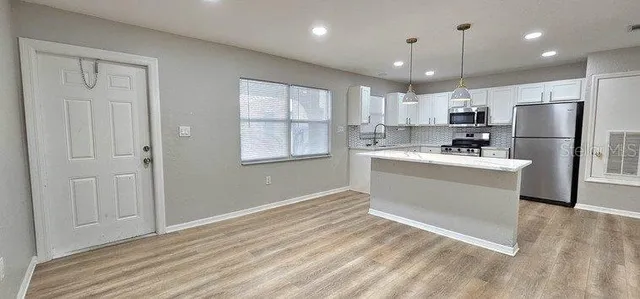 a view of kitchen with wooden floor