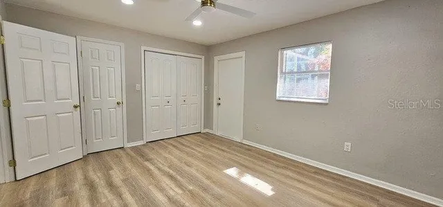 a view of room with window and ceiling fan