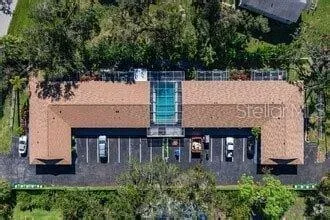 an aerial view of a house with balcony and garden