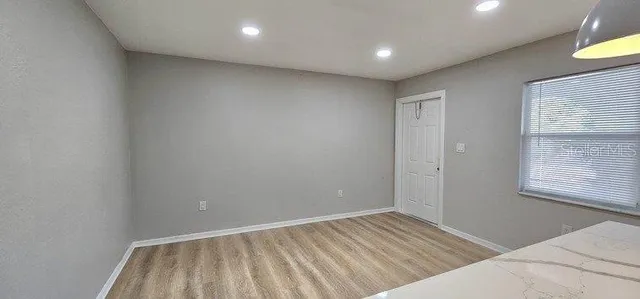 a view of an empty room with a window