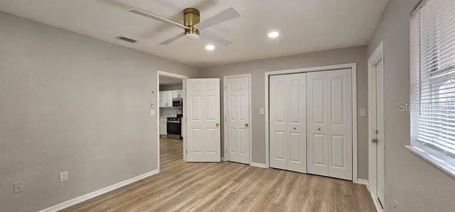 a kitchen with a refrigerator a sink and cabinets