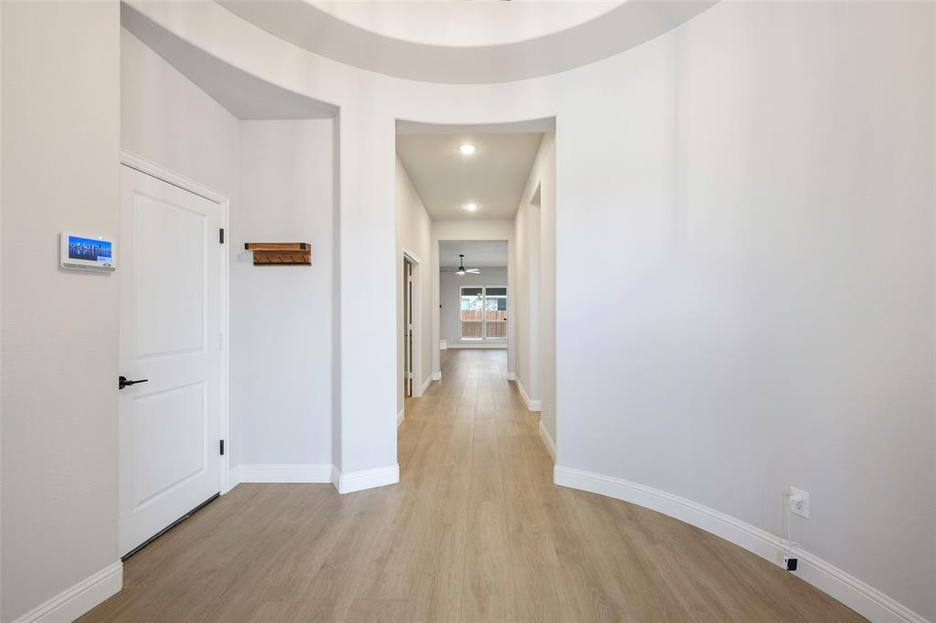 226 Comanche Trail Alvarado, TX 76009 - Photo 12 of 28 a view of a hallway with wooden floor