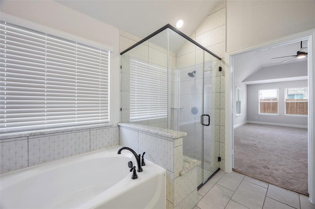 226 Comanche Trail Alvarado, TX 76009 - Photo 15 of 28 a bathroom with a bathtub and a shower