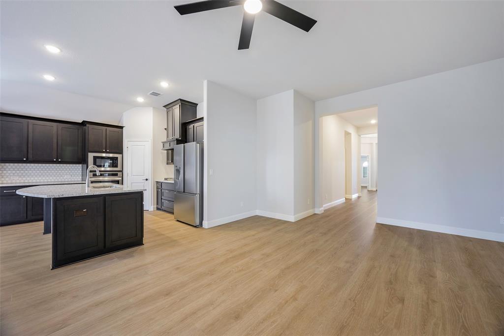 226 Comanche Trail Alvarado, TX 76009 - Photo 6 of 28 a large kitchen with stainless steel appliances a refrigerator and a stove top oven