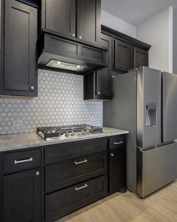 226 Comanche Trail Alvarado, TX 76009 - Photo 10 of 28 a kitchen with stainless steel appliances wooden cabinets and a counter space