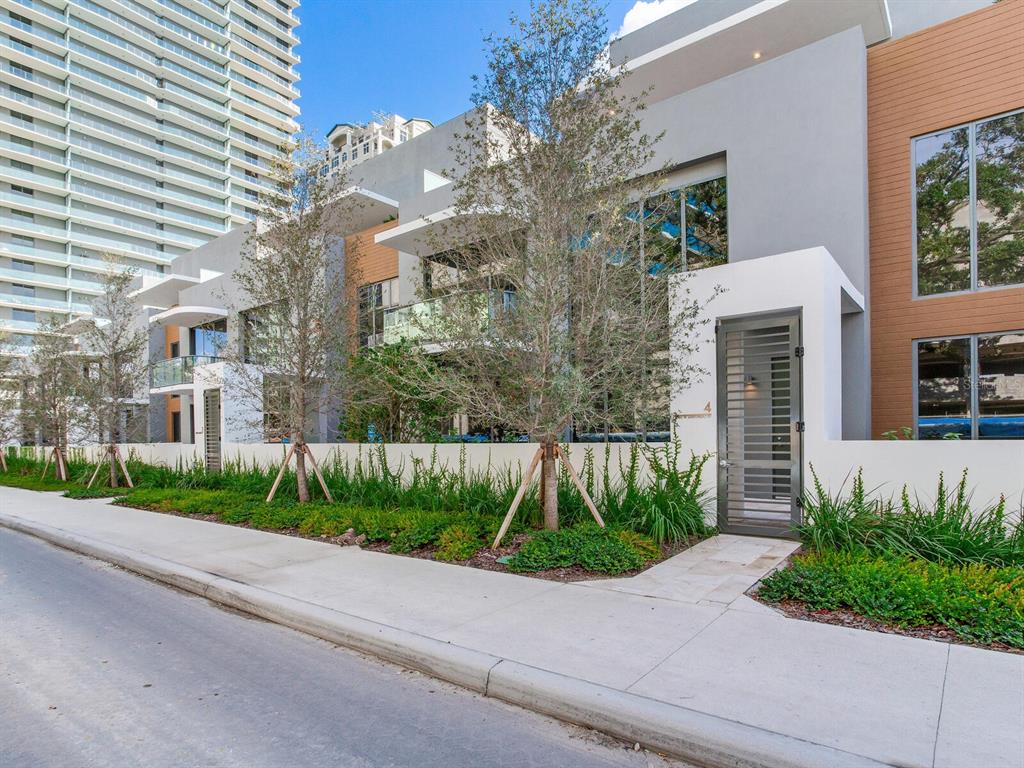 3020 West Santiago Street, Unit 4 Tampa, FL 33629 - Photo 2 of 99 a front view of a house with a yard and potted plants
