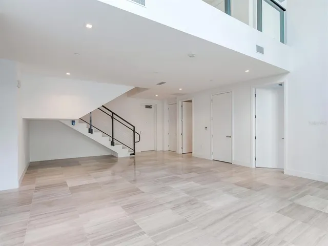 a bathroom with a granite countertop shower a mirror and a toilet