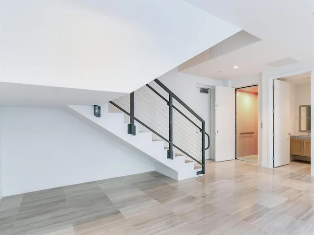 a spacious bathroom with a tub sink and mirror