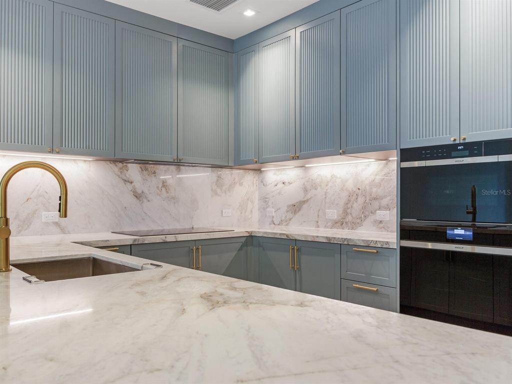 3020 West Santiago Street, Unit 4 Tampa, FL 33629 - Photo 48 of 99 a kitchen with granite countertop a sink and a stove top oven