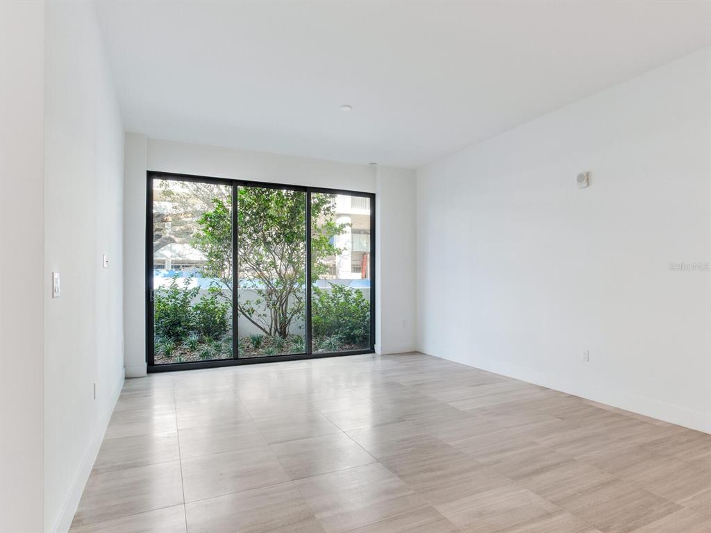 3020 West Santiago Street, Unit 4 Tampa, FL 33629 - Photo 52 of 99 an empty room with wooden floor and windows