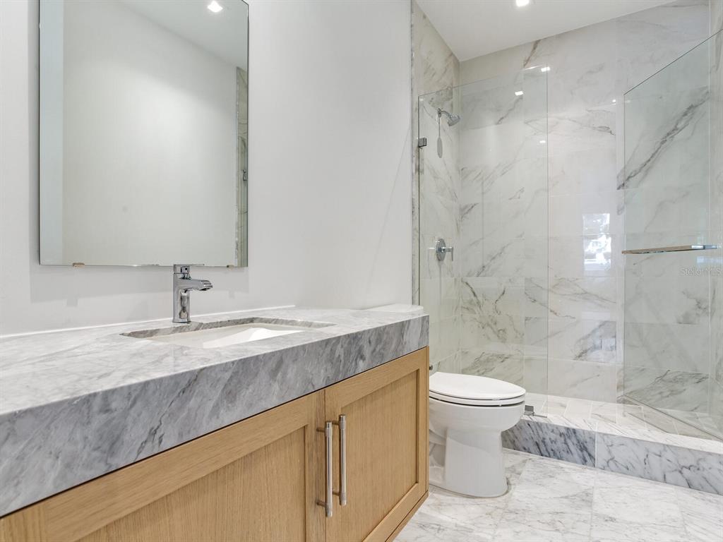 3020 West Santiago Street, Unit 4 Tampa, FL 33629 - Photo 59 of 99 a bathroom with a granite countertop sink a toilet and shower