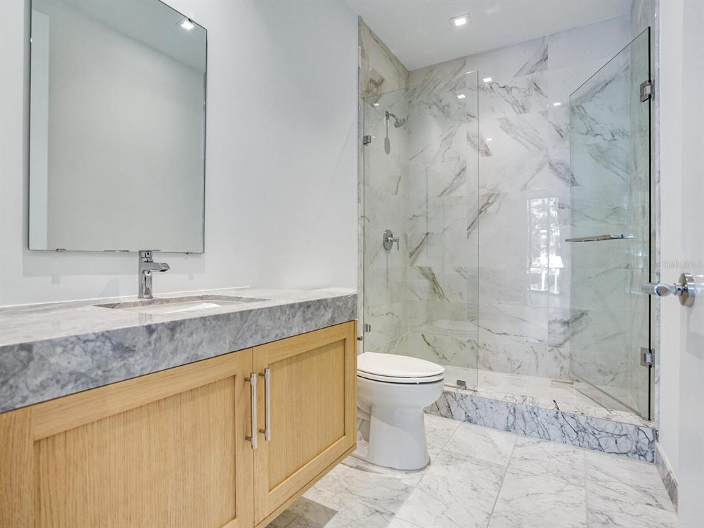 3020 West Santiago Street, Unit 4 Tampa, FL 33629 - Photo 68 of 99 a bathroom with a granite countertop sink a toilet and shower