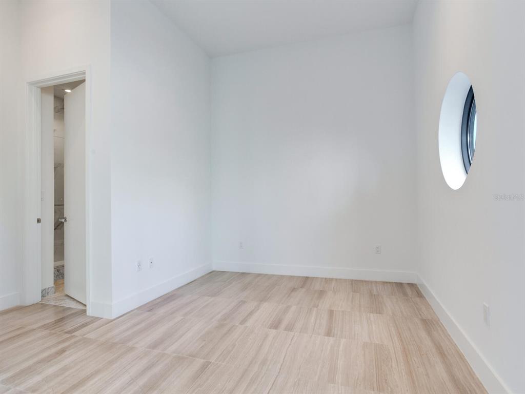 3020 West Santiago Street, Unit 4 Tampa, FL 33629 - Photo 88 of 99 a view of a room with wooden floor and a white wall