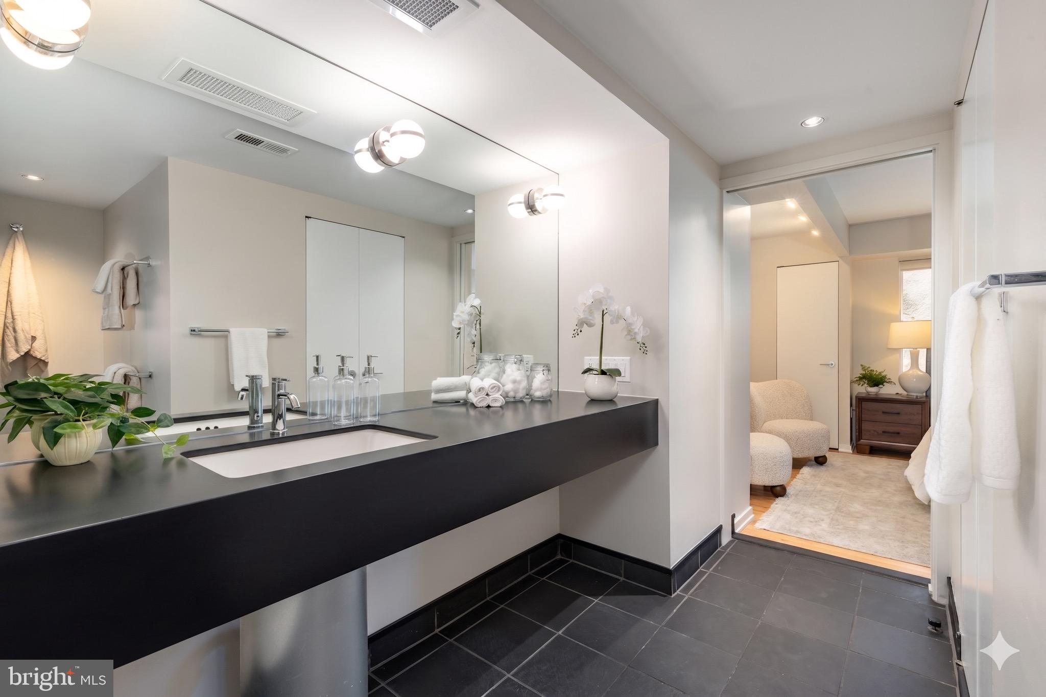 406 South 6th Street Philadelphia, PA 19147 - Photo 25 of 56 a bathroom with a double vanity sink and mirror