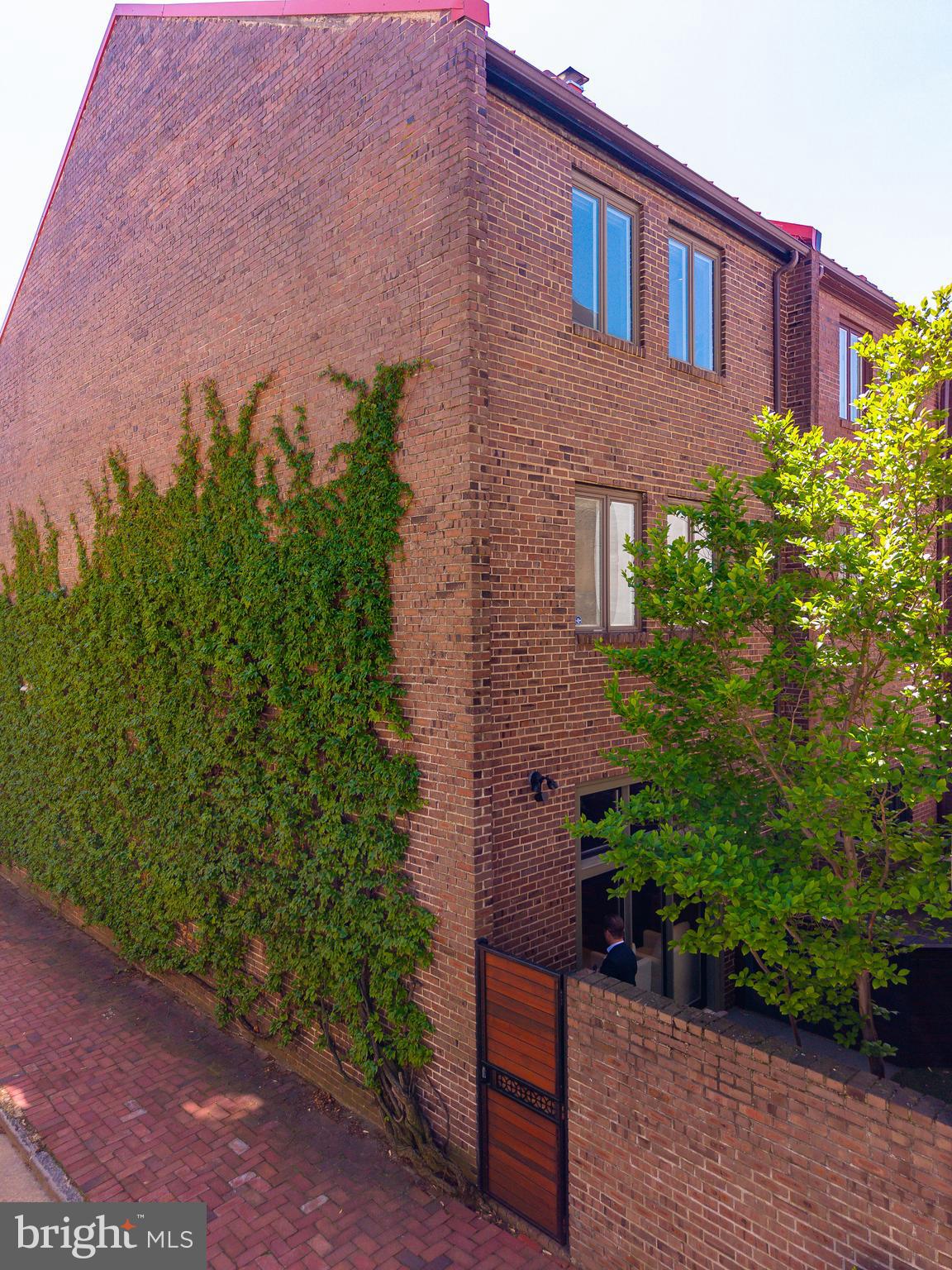 406 South 6th Street Philadelphia, PA 19147 - Photo 55 of 56 a view of a brick house with a yard and plants