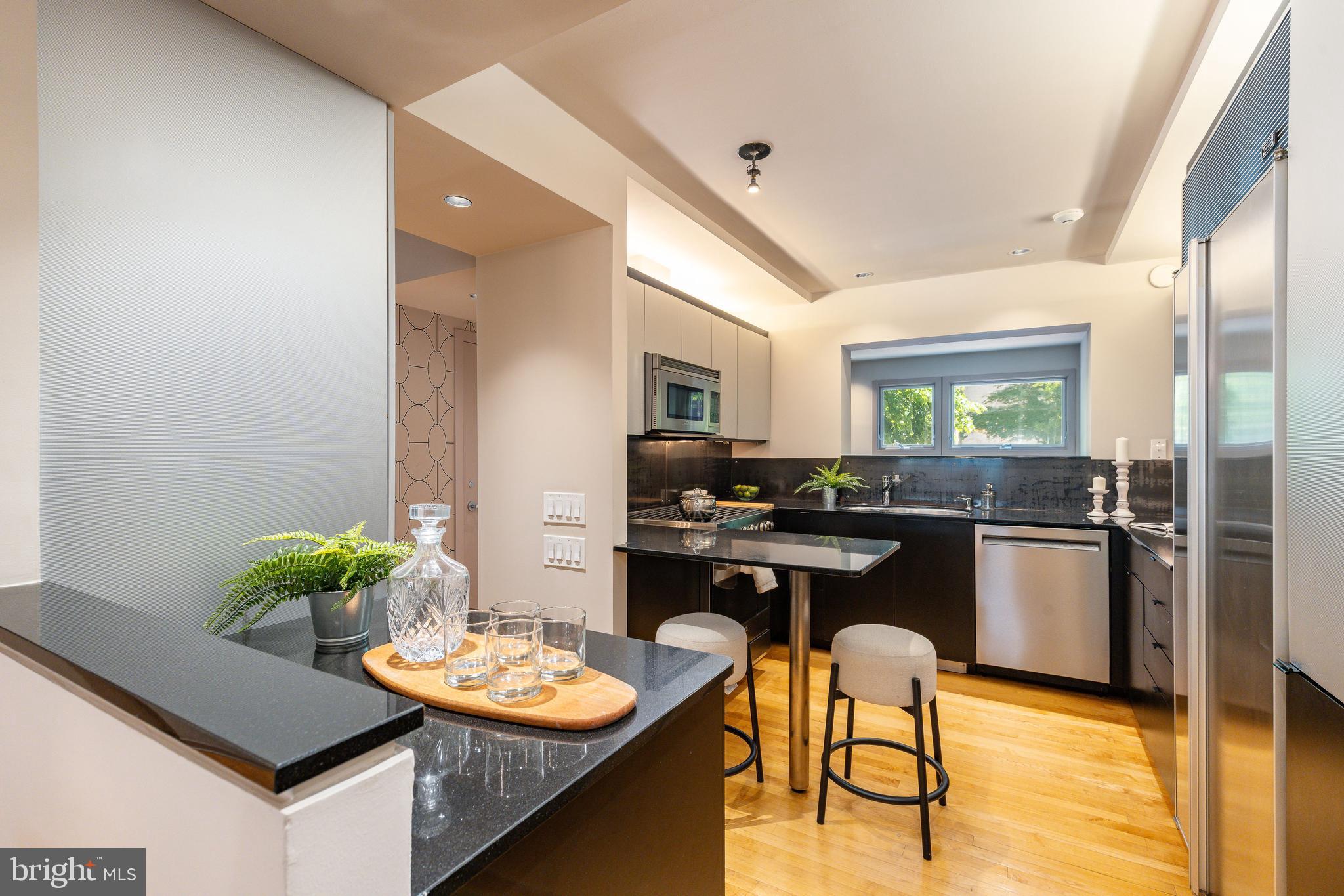 406 South 6th Street Philadelphia, PA 19147 - Photo 9 of 56 a kitchen with a table and chairs in it