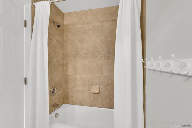 a bathroom with a shower and a bath tub