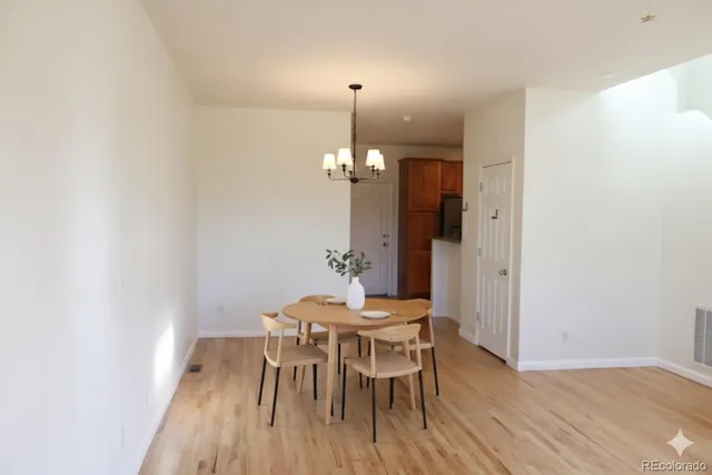 a dining room with furniture and wooden floor
