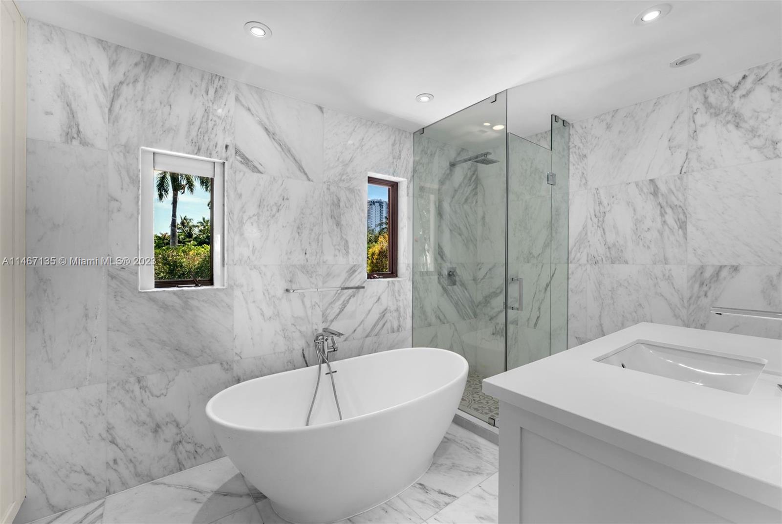 2201 Sunset Drive Miami Beach, FL 33140 - Photo 24 of 35 a white bath tub sitting next to a white sink and a toilet