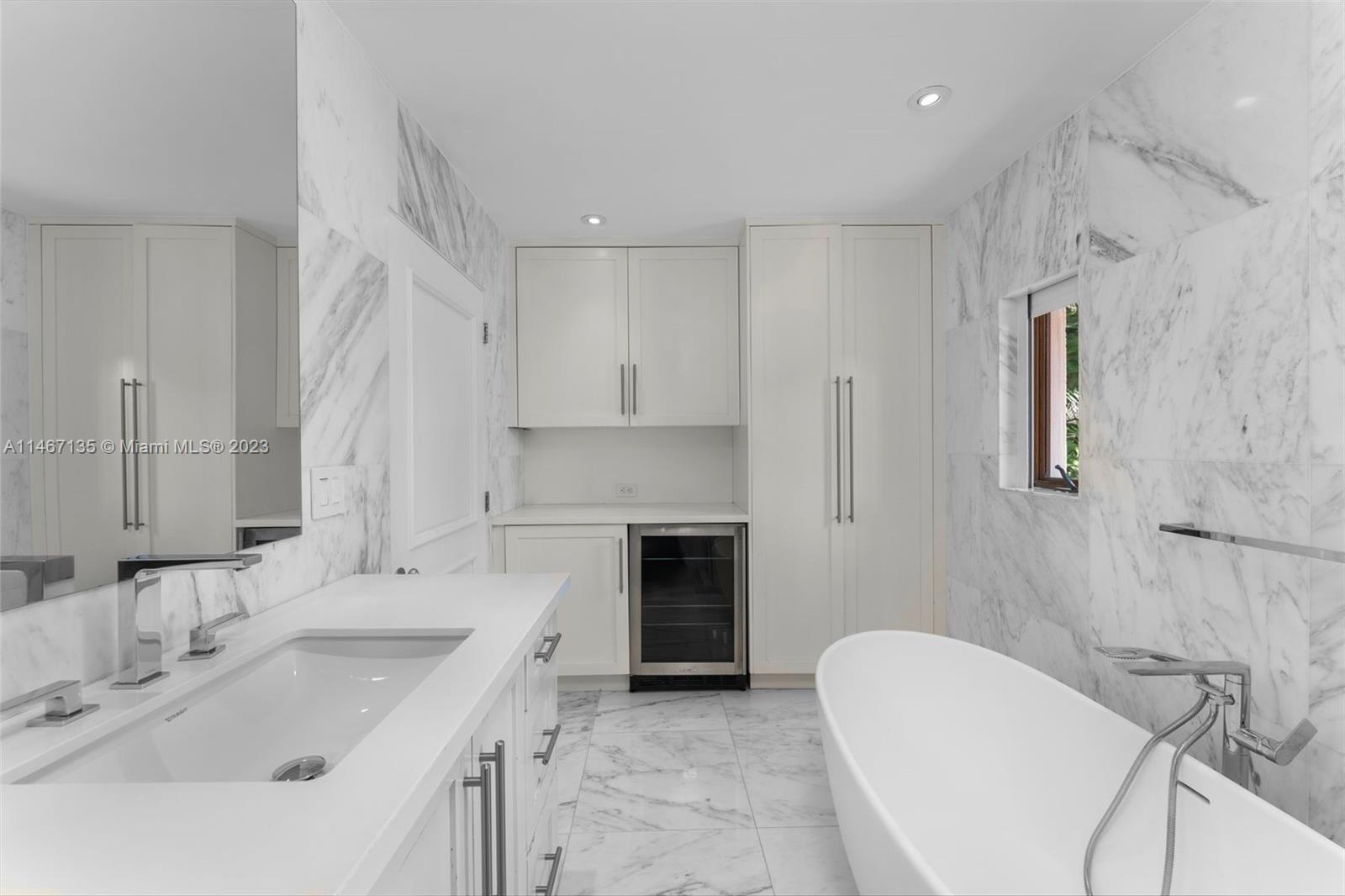2201 Sunset Drive Miami Beach, FL 33140 - Photo 25 of 35 a bathroom with a granite countertop sink a toilet a shower and a mirror