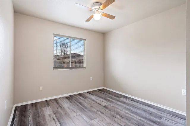wooden floor in an empty room with a window