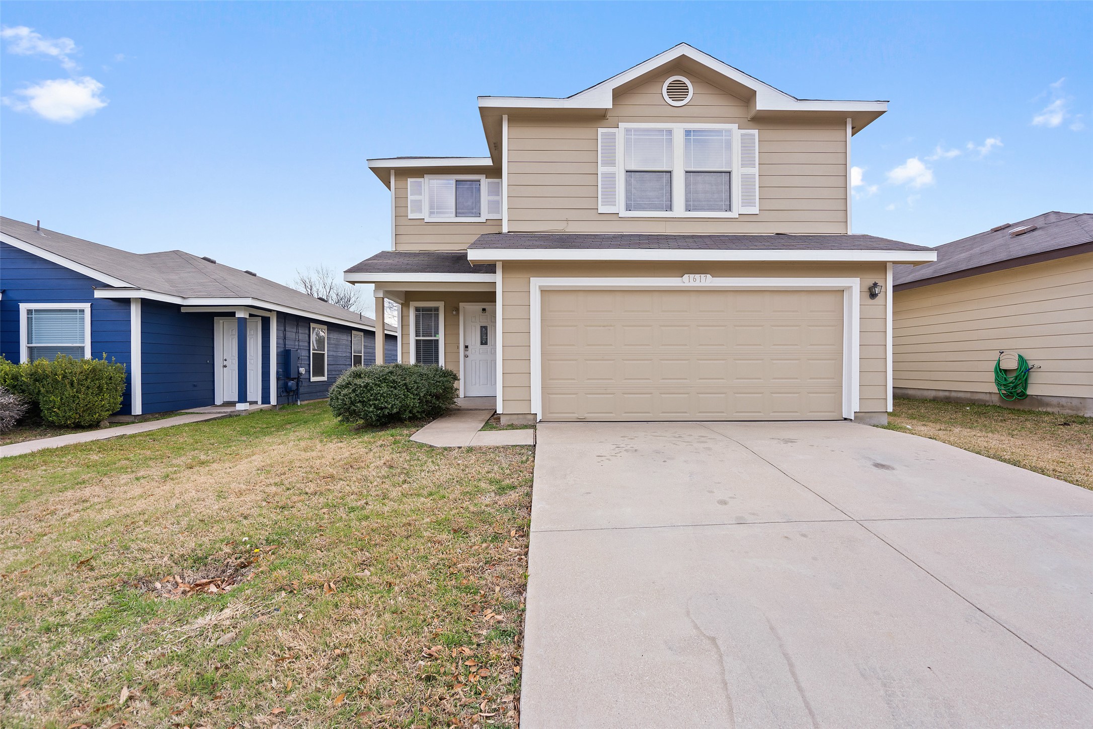 1617 Anise Drive Austin, TX 78741 - Photo 2 of 35 Traditional home with a garage, a front yard, roof with shingles, and concrete driveway