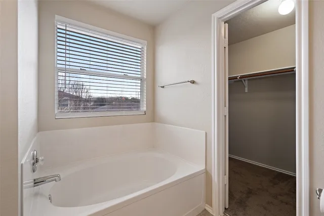 a white bath tub sitting next to a window