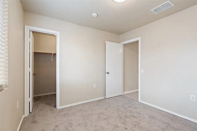 a view of an empty room and closet area