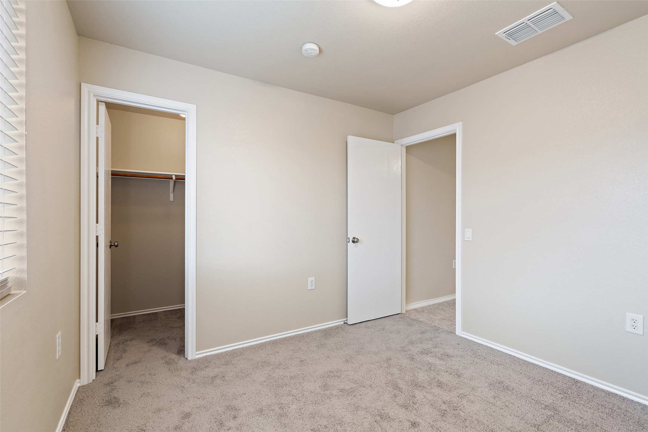 1617 Anise Drive Austin, TX 78741 - Photo 26 of 35 Unfurnished bedroom with carpet and a spacious closet