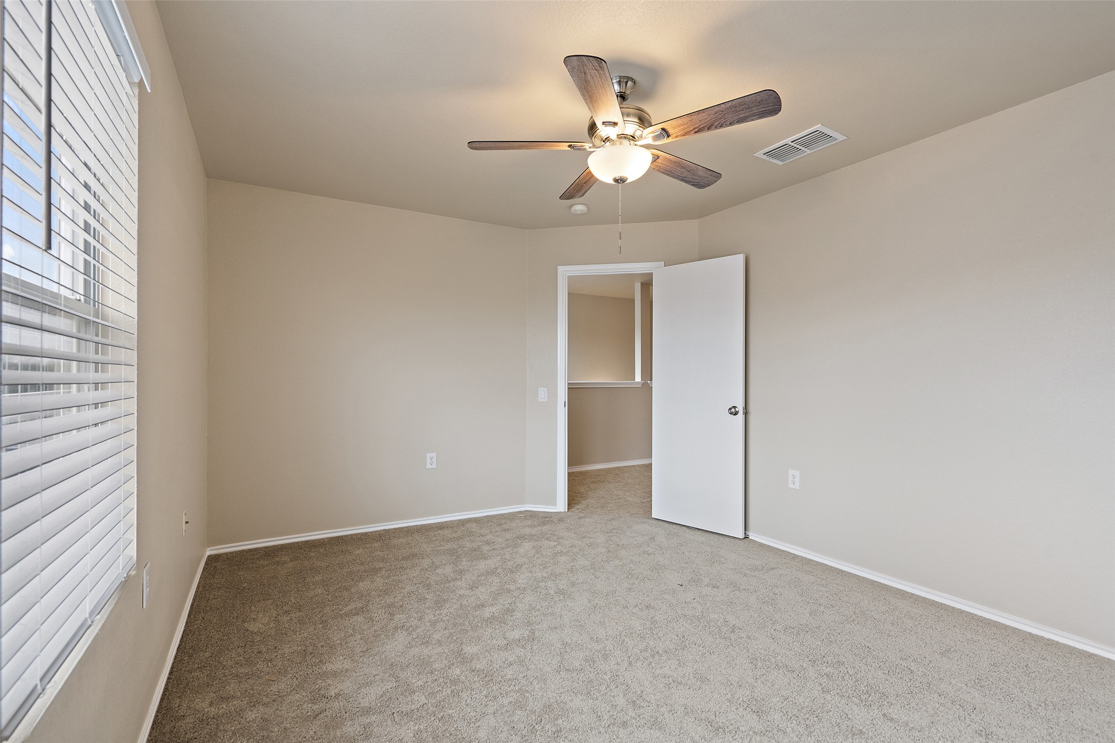 1617 Anise Drive Austin, TX 78741 - Photo 29 of 35 Empty room with a ceiling fan and carpet