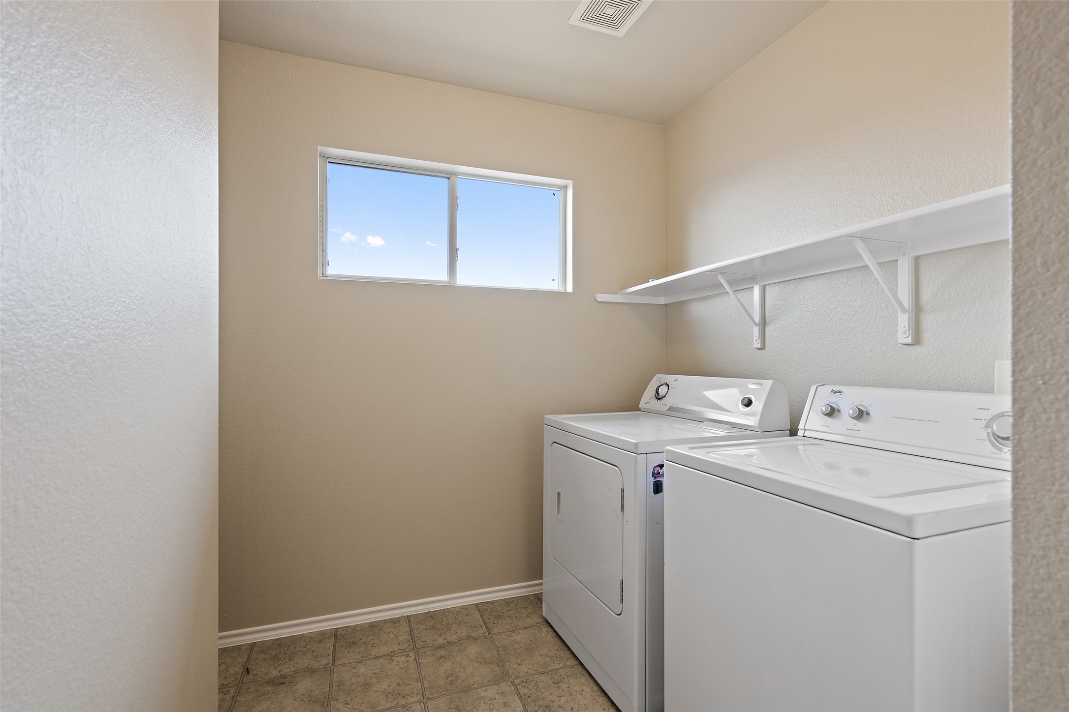 1617 Anise Drive Austin, TX 78741 - Photo 31 of 35 Washroom with washer and clothes dryer and baseboards