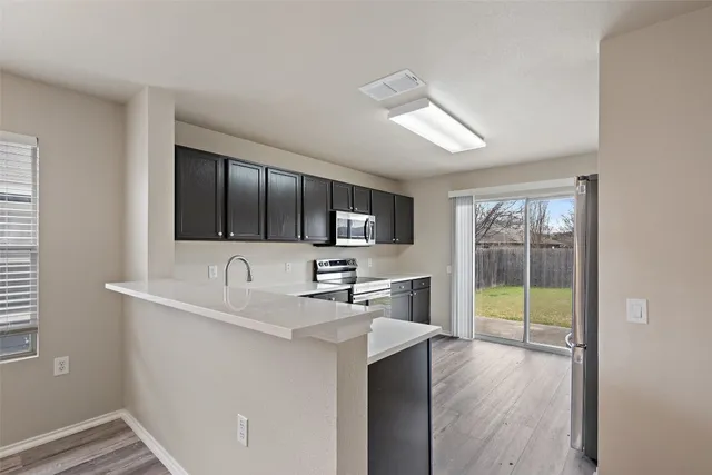 a kitchen with sink and microwave