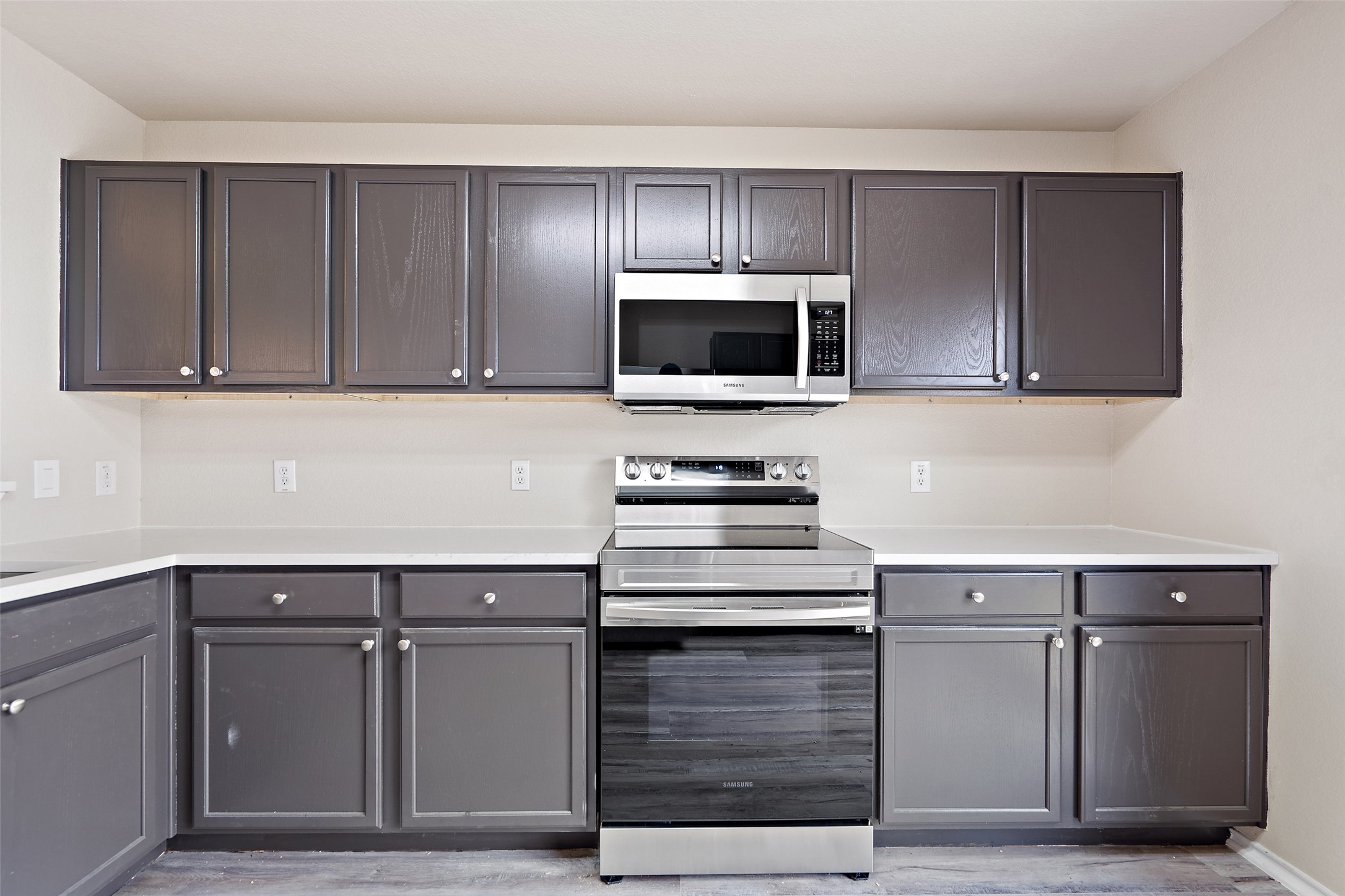 1617 Anise Drive Austin, TX 78741 - Photo 10 of 35 Kitchen with appliances with stainless steel finishes, gray cabinets, and light wood-type flooring