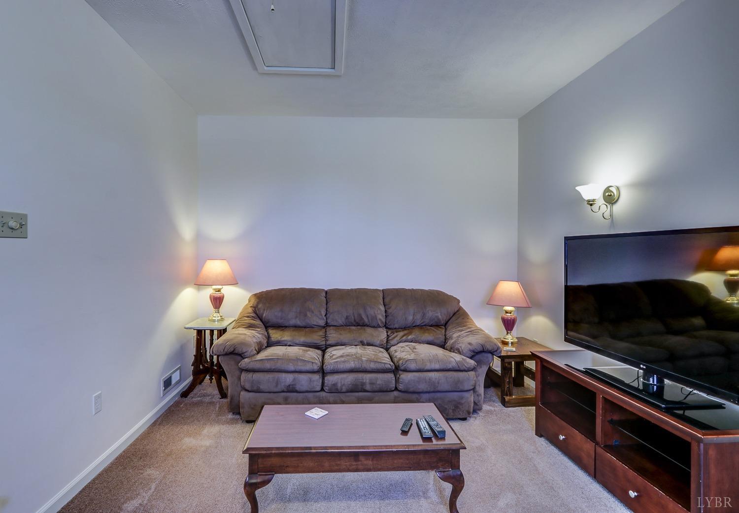 721 Doss Road Concord, VA 24538 - Photo 12 of 35 a living room with furniture and a flat screen tv
