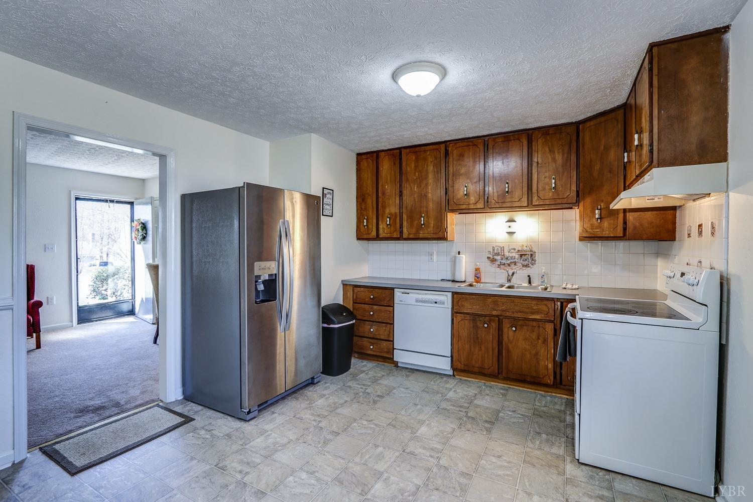 721 Doss Road Concord, VA 24538 - Photo 16 of 35 a kitchen with stainless steel appliances granite countertop a refrigerator stove and sink